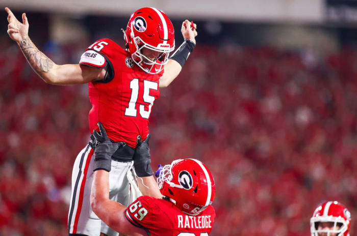 Georgia quarterback Carson Beck (15) is hoisted into the air by Georgia offensive guard Tate Ratledge (69) after scoring a touchdown versus UAB on Sept. 23, 2023 (Tony Walsh / UGAAA).